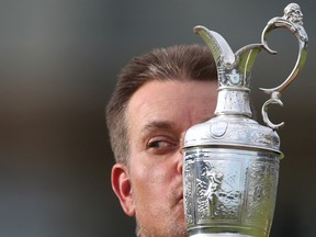 Henrik Stenson of Sweden kisses the trophy after winning the British Open at the Royal Troon Golf Club in Troon, Scotland, on July 17, 2016. (AP Photo/Peter Morrison)
