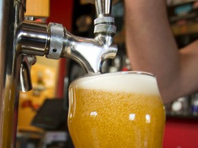 A a pint of beer is poured at Village Brewery in Calgary, Alta., on Monday, July 18, 2016. The province is changing its beer tax system, replacing a graduated markup system for beers from B.C., Alberta and Saskatchewan with a flat $1.25-per-litre charge. Lyle Aspinall/Postmedia Network