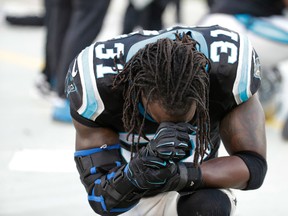 Carolina Panthers cornerback Charles Tillman prays on the sidelines during an injured player timeout in the first quarter against the Tampa Bay Buccaneers at Bank of America Stadium. (Jeremy Brevard-USA TODAY Sports)