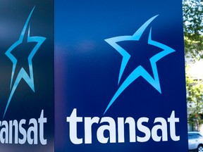 An Air Transat sign is seen in Montreal in a May 31, 2016, file photo. Authorities say two commercial airline pilots have been arrested at Glasgow Airport on suspicion of being under the influence of alcohol, shortly before they were due to take off on a trans-Atlantic flight. Canadian airline Air Transat says the two crew members were arrested before a Glasgow to Toronto flight on Monday. (THE CANADIAN PRESS/Paul Chiasson, File)