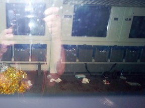 Blood stains and a rescue blanket are seen through the windows of a train in Wuerzburg, southern Germany, Monday evening, July 18, 2016, after a 17-year-old Afghan armed with an axe and a knife attacked passengers aboard a regional train in southern Germany, injuring four people before he was shot and killed by police as he fled. (Karl-Josef Hildenbrand/dpa via AP)
