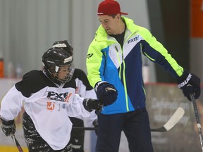 Winnipeg Jets centre Mark Scheifele works with young players during a KidSport hockey camp last month. (Brian Donogh/Winnipeg Sun file photo)