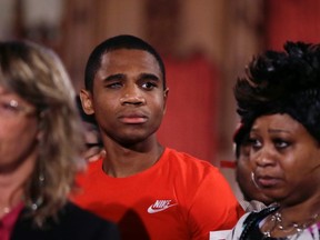 Davontae Sanford stands with his mother, Taminko Sanford, right, as attorney Valerie Newman addresses the media during a news conference, Thursday, June 9, 2016 in Detroit. Sanford entered prison as a teenager in 2008 and was released Wednesday, a day after his guilty pleas to four fatal shootings were erased by a judge at the request of prosecutors who conceded the case was compromised by flawed police work. (AP Photo/Carlos Osorio)