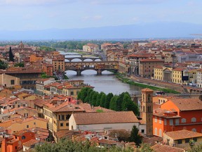 This photo taken April 18, 2016, shows the old city of Florence, Italy, flanking the River Arno as viewed from the Piazzale Michelangelo. The piazzale, a square in the hills above the city, is a great place to take in the views, especially at sunset. (Michelle Locke via AP)
