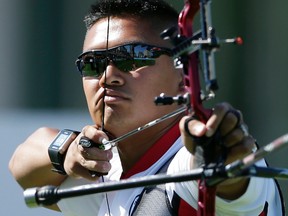 Canada's Crispin Duenas competes during an individual elimination round in archery competition in the Pan Am Games in Toronto on July 16, 2015. (AP Photo/Gregory Bull)