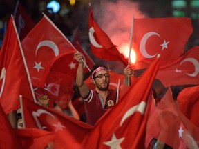A man waves a Turkish flags during a meeting in support of the Turkish president on Taksim Square in Istanbul on July 19, 2016. (AFP PHOTO / DANIEL MIHAILESCUDANIEL MIHAILESCU/AFP/Getty Images)