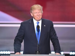 Presumptive Republican presidential candidate Donald Trump introduces his wife Melania Trump (out of frame) to delegates on the first day of the Republican National Convention on July 18, 2016 at Quicken Loans Arena in Cleveland, Ohio.
The Republican Party opened its national convention, kicking off a four-day political jamboree that will anoint billionaire Donald Trump as its presidential nominee.  / AFP PHOTO / Robyn BECKROBYN BECK/AFP/Getty Images