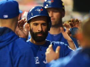Jose Bautista of the Toronto Blue Jays is congratulated by teammates after scoring a run in the fourth inning against the Philadelphia Phillies at Citizens Bank Park on June 16, 2016 in Philadelphia, Pennsylvania. (Drew Hallowell/Getty Images)