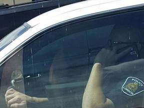 This London police officer was spotted on the phone while behind the wheel of his cruiser Sunday at Wonderland Road and Oxford Street. (Submitted photo)