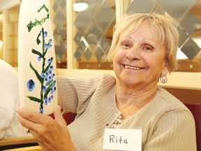 Rita Faulkner shows off her blueberry paddle she created at a paddle decorating workshop at the Alzheimer's Health Bistro day program in Sudbury, Ont. on Tuesday July 19, 2016. People can decorate their own paddle at the Sudbury Blueberry Festival Blueberry Bash at The Market on Saturday, July 23. Lacasse Fine Wood Products will provide the paddles for a $20 donation that will go to the Alzheimer's Health Bistro. John Lappa/Sudbury Star/Postmedia Network