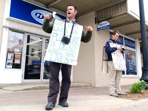 London street preachers Steven Ravbar, left, and Matthew Carapella spent a couple hours on the corner of Queen and Lambton June 28 speaking to passers-by about their views on the LGBT community and the so-called immodesty of young women. (Darryl Coote/Reporter)