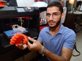 Moath Abuaysha holds part of an artificial hand he created on his 3D printer. The 23-year-old western student is now printing a prosthetic arm for a Syrian child war amputee.
MORRIS LAMONT  / THE LONDON FREE PRESS / POSTMEDIA NETWORK