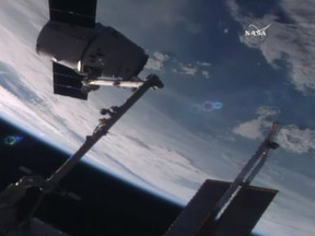 In this frame from NASA TV, the SpaceX Dragon capsule arrives at the International Space Station bearing supplies on Wednesday, July 20, 2016. The shipment includes a docking port needed for future rocket ships. (NASA TV via AP)