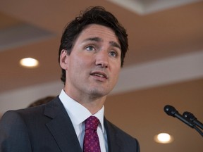 Canadian Prime Minister Justin Trudeau listens to a question as he speaks with the media following a child care benefit announcement Wednesday July 20, 2016 in Aylmer, Que. THE CANADIAN PRESS/Adrian Wyld