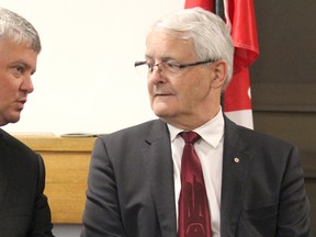 Sault Ste. Marie MP Terry Sheehan and Transport Minister Marc Garneau speak before a funding announcement at Sault Ste. Marie Airport on Wednesday.