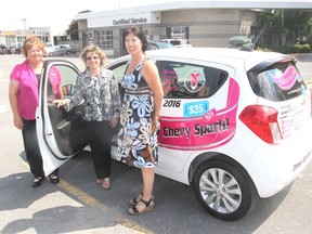 Taylor Auto Mall employees Donna Tregunna, left, Re Haslett and Melodie Quinn, in Kingston, Ont. on Monday, July 18, 2016, stand with the 2017 Chevrolet Spark the dealership is raffling off to raise money for Breast Cancer Action Kingston. Michael Lea The Whig-Standard Postmedia Network