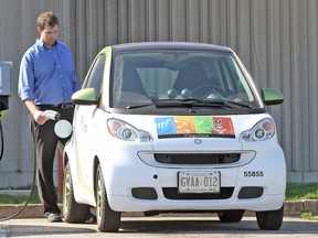 Mark Buma, the assistant properties manager at the Niagara Parks Commission, with one of the two electric Smart cars being used by the commission as part of its ongoing effort to be green in this undated file photo. (MIKE DIBATTISTA /NIAGARA FALLS REVIEW/Postmedia Network)