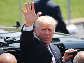 Republican presidential nominee Donald Trump waves to supporters after arriving in Cleveland on the third day of the Republican National Convention on July 20, 2016, in Cleveland, Ohio. (AFP PHOTO/DOMINICK REUTERDOMINICK REUTER/AFP/Getty Images)