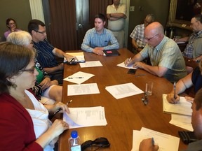 Uber spokesman Chris Schafer, at centre, answers questions from members of the Kingston Area Taxi Commission on Wednesday evening at City Hall. (Paul Schliesmann/The Whig-Standard)