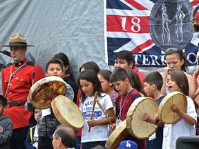 Children drum and sing traditional Cree songs before federal ministers Carolyn Bennett and Amarjeet Sohi at Enoch Cree Nation on Wednesday, July 20, 2016.