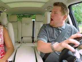 First lady Michelle Obama, left, and James Corden, host of "The Late Late Show with James Corden," appear during the taping of a Carpool Karaoke segment. (CBS via AP)