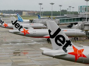 Three Jetstar Asia Airbus A320 fleets are berth at the Terminal One of Changi International Airport in Singapore, in this Dec. 13, 2004 file photo. (ROSLAN RAHMAN/AFP/Getty Images)
