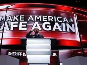 David Clarke, Sheriff of Milwaukee County, Wis., salutes as he addresses the delegates during the opening day of the Republican National Convention in Cleveland, Monday, July 18, 2016. (AP Photo/Carolyn Kaster)