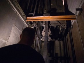 A building manager is pictured in an elevator pit in a downtown Toronto office building on Wednesday July 13, 2016. Every day of the year, a growing number of Canadians across the country are finding themselves trapped in faulty elevators, while countless more are suffering through inconvenience and isolation because of elevators that are out of service, an investigation by The Canadian Press has found. Last year, for example, firefighters in Ontario responded to 4,461 calls to extricate people stuck in elevators -- more than a dozen a day -- and double the number from 2001. THE CANADIAN PRESS/Chris Young