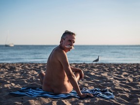 Stephane Deschenes, nudist and owner of Bare Oaks Family Naturist Park, poses for a photo at Hanlan's Point beach on Toronto Island on Thursday, July 14, 2016. THE CANADIAN PRESS/Aaron Vincent Elkaim
