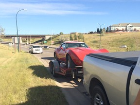 Coaldale RCMP arrested a 46-year-old Calgary man after conducting a vehicle stop at Scenic Drive and Hwy 3 which confirmed the red 1976 Chevy Corvette the grey Dodge was towing was, in fact, stolen. | Contributed photo/Coaldale RCMP