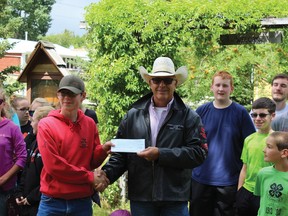 Shell Waterton Community Liaison Officer Rod Sinclair presents 4-H district representative Justin Schoening with a $10,000 cheque donation. Shell Waterton has played a critical role in the community for decades, and its closure could greatly impact Pincher Creek.