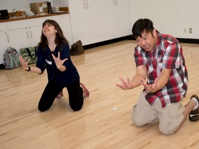 Drama instructors Matthew Ma and Rebecca Considine make faces and sounds during an energy game on the first day of the FoOtlights drama summer camp at Border Paving Athletics Centre in Spruce Grove on Monday, July 18, 2016. - Photo by Yasmin Mayne