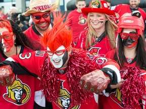 Steve Barnett (centre) is all painted up along with his buddies outside Canadian Tire Centre prior to a game between the Montreal Canadiens and the Ottawa Senators. Wayne Cuddington / Postmedia