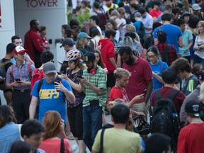 People play Pokemon Go at the base of the CN Tower  on Monday July 18, 2016. Craig Robertson/Toronto Sun/Postmedia Network