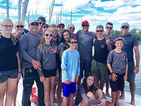 Youth racers and coaches from the BQYC recently competed in Port Credit where they met Picton native and world solo sailor, Sandy Macpherson (red cap at right). (Submitted photo)