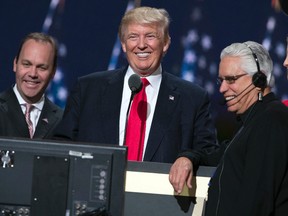 Republican presidential candidate Donald Trump, center, smiles as he talks with production crew during a walk through in preparation for his speech at the Republican National Convention, Thursday, July 21, 2016, in Cleveland. (AP Photo/Evan Vucci)