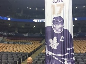 Wendel Clark poses for a photo beside his banner as it comes down from the rafters at the Air Canada Centre on Thursday, July 21, 2016 (Lance Hornby/Toronto Sun/Postmedia Network)