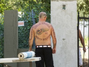 A Hells Angels Nomads member at the front gate of the group's compound in Carlsbad Springs. Bruce Deachman/Postmedia