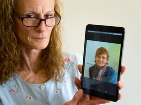 Patricia McGrath-Gawrylash holds a photo of her sister, Debbie McGrath, who died after she was struck by a London Transit bus Monday. (MIKE HENSEN, The London Free Press)