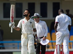 India’s Virat Kohli celebrates 100 runs during Day 1 of their test against the West Indies. (Getty Images)