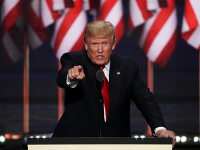 Republican presidential candidate Donald Trump points to the crowd as he delivers a speech during the evening session on the fourth day of the Republican National Convention on July 21, 2016 at the Quicken Loans Arena in Cleveland, Ohio. Republican presidential candidate Donald Trump received the number of votes needed to secure the party's nomination. An estimated 50,000 people are expected in Cleveland, including hundreds of protesters and members of the media. The four-day Republican National Convention kicked off on July 18.  (Photo by Alex Wong/Getty Images)