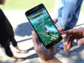 Dozens of Pokemon Go players play over the lunch hour. (Gavin Young/Postmedia)