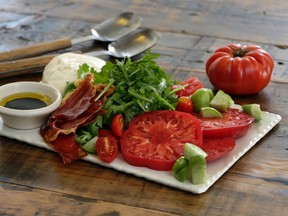 This May 23, 2016 photo shows a caprese salad with crispy prosciutto, from a cookbook by swimsuit model Chrissy Teigen and styled by Sarah Abrams, at the Institute of Culinary Education in New York. Adapted by Elizabeth Karmel from Teigen 's "Cravings: Recipes for All the Food You Want to Eat," the salad calls for tomatoes in different shapes and sizes - some slices, some wedges - served with arugla and crunchy, hammy, prosciutto crisps.