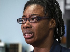 In this July 19, 2016 photo, Breaion King is overcome with emotion as she describes being pulled from her car and thrown to the ground by an Austin police officer during a traffic stop in 2015, during an interview held at her attorney, Erica Grigg's office in Austin, Texas. Patrol car video publicly released Thursday, July 21, 2016, shows a white Austin, Texas, police officer violently throwing King to the ground during a traffic stop, followed by another white officer telling her black people have "violent tendencies" and whites are justifiably afraid. (Rodolfo Gonzalez/Austin American-Statesman via AP)