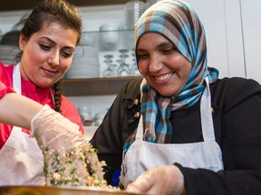 Rahalf Alakbani and Majeda El Mafaalani prepare a typical Syrian meal in Toronto on Thursday July 7, 2016. The Newcomer Kitchen Project is an initiative for recent Syrian migrant women, organized by Len Senater and Cara Benjamin-Pace at the Depanneur restaurant in Toronto. (THE CANADIAN PRESS/Christopher Katsarov)