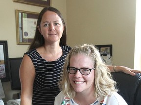 Dr. Karen Yeates, left, and Jessica Sleeth, in Etherington Hall in Kingston, Ont. on Thursday, July 21, 2016, are part of a project at Queen's University that sees smartphones used by healthcare providers in Tanzania to screen women for cervical cancer. Michael Lea The Whig-Standard Postmedia Network