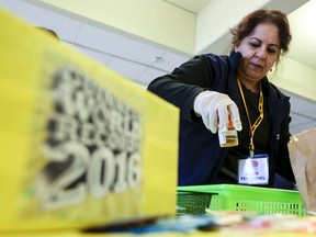 Vida Faraz, an Ottawa Public Health volunteer collects urine samples from people taking part in the Pee to See Challenge at the University of Ottawa in March.The challenge was aimed to break a Guiness World Record for the most Chlamydia and gonorrhea urine tests completed within 24 hours in a single venue. Darren Brown/Postmedia