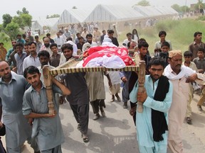 Pakistani relatives and residents carry the coffin of social media celebrity, Qandeel Baloch during her funeral in Shah Sadar Din village, around 130 kilometers from Multan on July 17, 2016. (Getty Images)