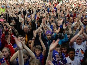 Icelandic soccer fans celebrate as their national team comes home from the Euro 2016 soccer championships in Reykjavik, Iceland, Monday July 4, 2016. (AP Photo/Brynjar Gunnarsson)