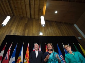 Ontario Premier Kathleen Wynne, right, British Columbia Premier Christy Clark, centre, and Quebec Premier Philippe Couillard share a laugh as they speak to the media during a meeting of Premiers in Whitehorse, Y.T., Friday, July, 22, 2016. THE CANADIAN PRESS/Jonathan Hayward